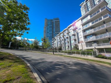 Modern estetik ve mavi gökyüzü arka planına sahip yerleşim kompleksi Port Moody, BC, Kanada.