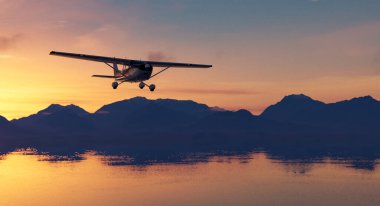 Renkli bir gün batımına karşı manzaralı dağların üzerinde uçan küçük bir uçak..