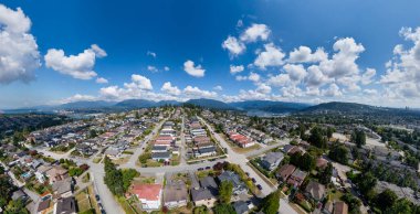 Büyük Vancouver, BC, Kanada 'daki Burnaby Banliyösünün panoramik hava manzarası, düzenli caddeler, sıralı evler ve çevre tepeler.