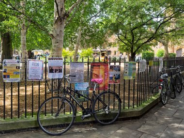 CAMBRIDGE, İngiltere - 11 Ağustos 2017: Bisikletler şehir merkezindeki All Saints Garden etrafındaki korkuluklara zincirlendi