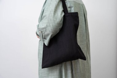 Kadınların elinde yeniden kullanılabilir siyah alışveriş torbası, sürdürülebilir günlük yaşam