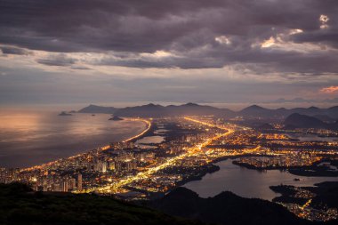 Beautiful view from mountain top to city lights during sunset time, Pedra Bonita Peak, Tijuca Park, Rio de Janeiro, Brazil