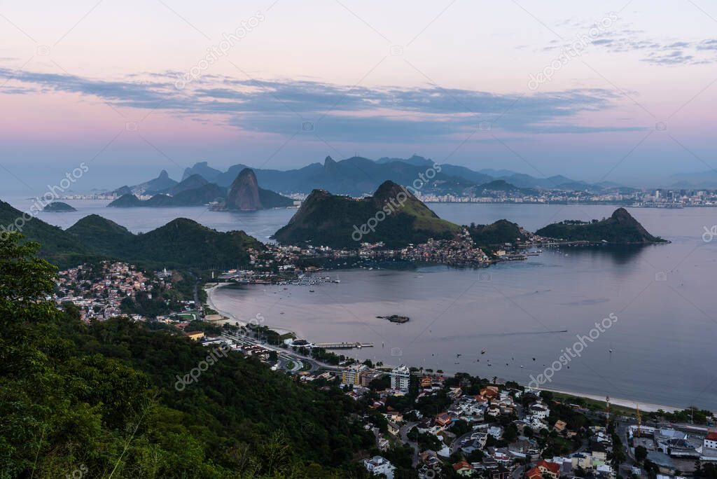 Beautiful sunrise view with pink sky to mountains and ocean in Rio de Janeiro, Brazil