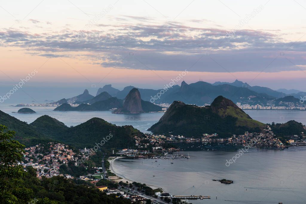 Beautiful sunrise view with pink sky to mountains and ocean in Rio de Janeiro, Brazil