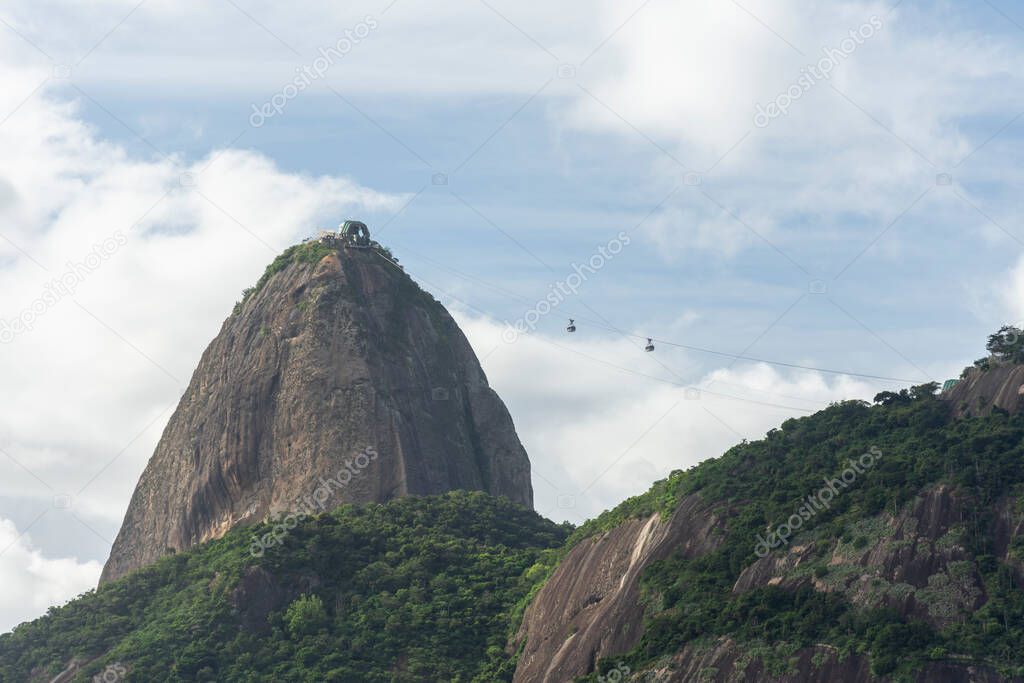 Beautiful view to Sugar Loaf Mountain with blue sky and white clouds in Rio de Janeiro, Brazil