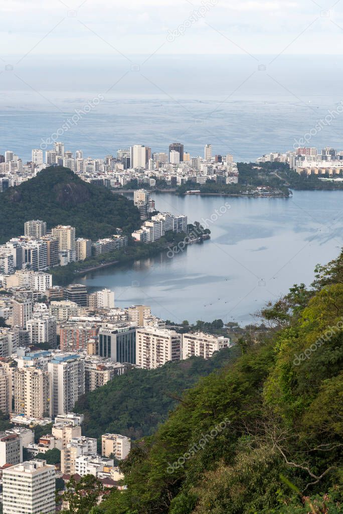 Beautiful view to city lake and green rainforest mountains in Rio de Janeiro, Brazil