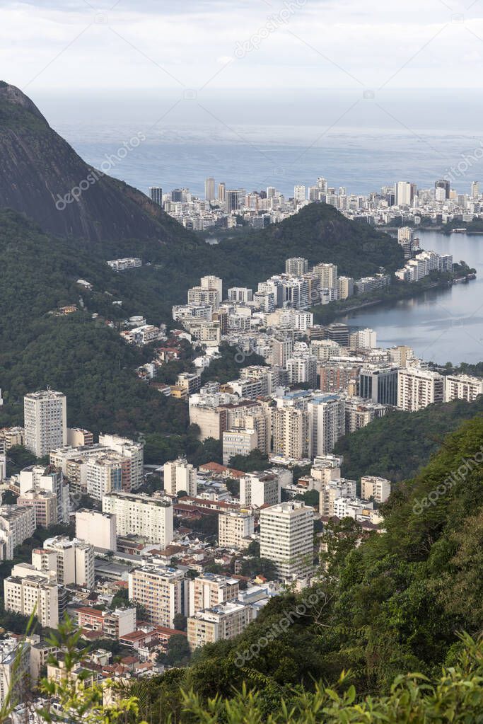 Beautiful view to city lake and green rainforest mountains in Rio de Janeiro, Brazil