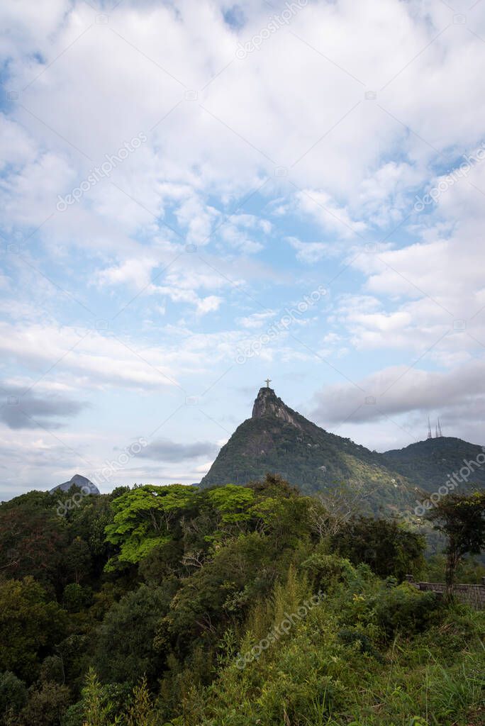 Beautiful view to Christ Statue on top of green rainforest mountain in Rio de Janeiro, Brazil