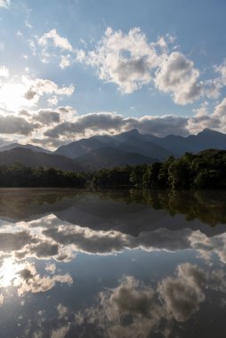 Brezilya 'nın Rio de Janeiro kentinin kırsal kesimindeki yeşil dağlara ve bulutlara güzel bir manzara yansıyor.