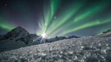 A breathtaking view of the Aurora Borealis illuminating a snow-covered mountain landscape, showcasing natures spectacular light show in the night sky.