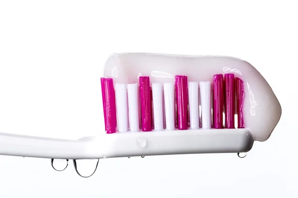 Tandenborstel met tandpasta en water druppels — Stockfoto
