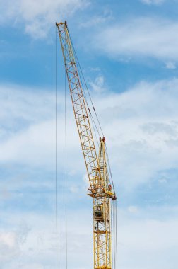 Mavi gökyüzüne karşı inşaat vinç kulesi.