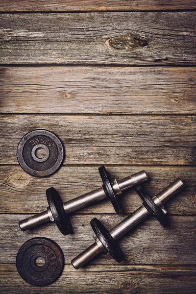 Fitness workout background. Dumbbells on wooden floor — Stock Photo, Image