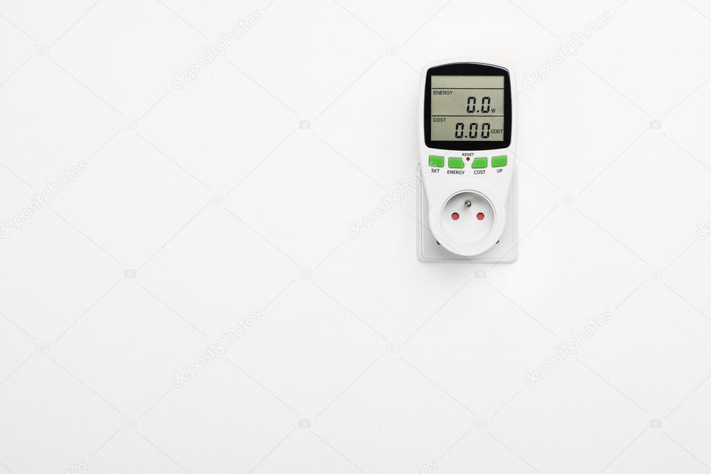Electric power consumption meter on white wall.