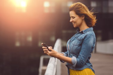 Young woman playing with the phone concept