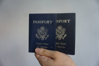 Elde tutulan bir Amerikan pasaportu yasal ikamet ve Amerikan vatandaşlığını gösteriyor. Yakın plan, belgenin kapağını ve özgünlüğünü vurgular.