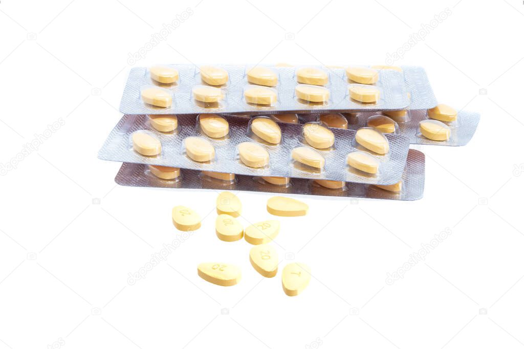 Blisters of brown pills and individual pills isolated on white background