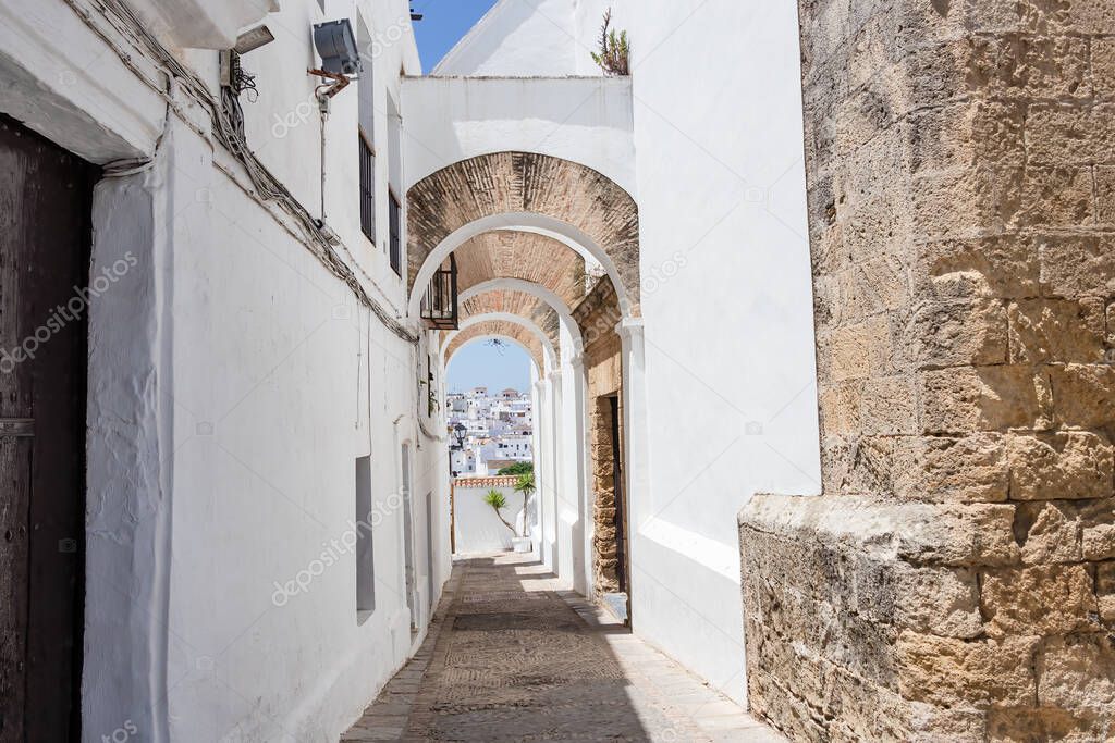 Arch in a typical street of the town of Vejer de la Frontera in Cadiz, Andalusia, Spain,