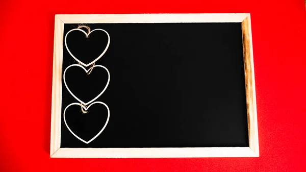 Black board of love on a red background.