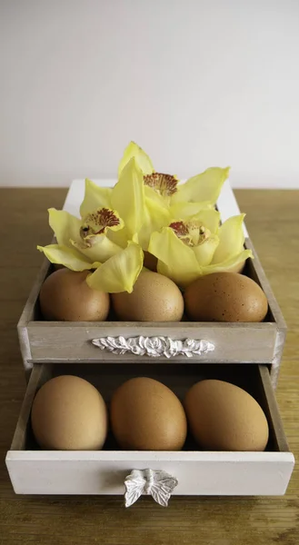 Wooden packaging for fresh chicken eggs. Farm products. Easter concept.