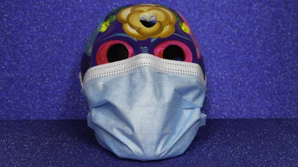 Sugar Skull with a medical mask. Day of the Dead at the time of the COVID-19.