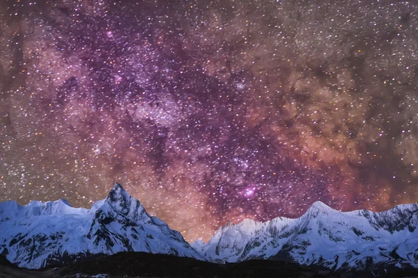 Güzel yıldızlı gökyüzü ve dağlarda kar, yıldızlı ve karlı gece gökyüzü.