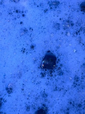 Pastel veya beyaz bir yüzey üzerinde yüzen yumuşak, şeffaf kabarcıklar içeren sanatsal bir soyut arkaplan.