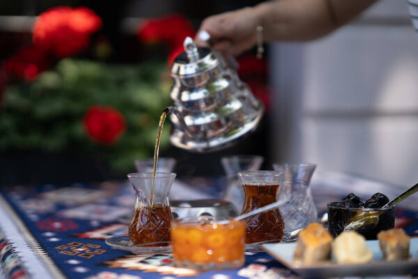 Pouring Hot Tea into Traditional Glass