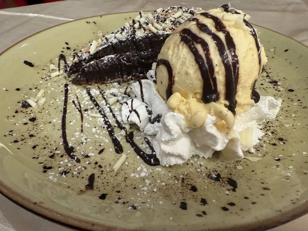 a decadent chocolate cake with vanilla ice cream and whipped cream dessert concept