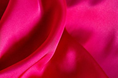 Pembe ipek kumaş dokusu arka planı. Makro. Soyut. Kusursuz bir geçmişi var. Kumaş pürüzsüz desenler. Yüksek kalite fotoğraf