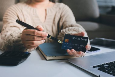 Kapanmış adam dizüstü bilgisayarı kullan kredi kartı kullan cep telefonu kullan kahve dükkanında masaya otur, dinlenme dinlenme dinlenme dinlenme dinlenme boş zamanlarında serbest mobil konsepte odaklan nesneye odaklan