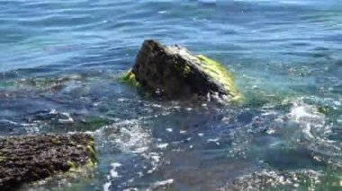 Sakin dalgalar kayalar isabet