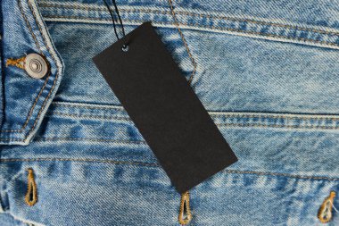 Close up view of denim fabric featuring a price tag
