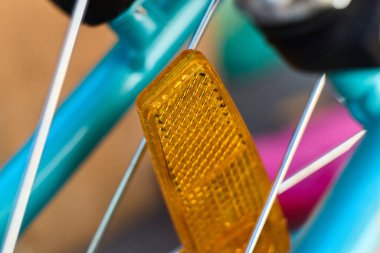 A close view shows a yellow reflector on a bike