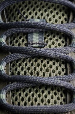 Detailed shot of shoe laces and breathable mesh fabric.