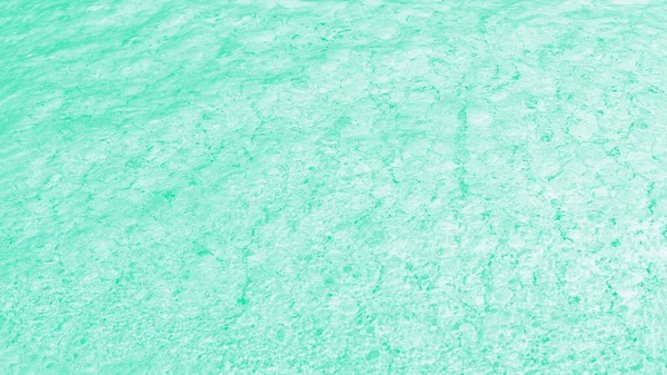 Green turquoise background, water glare pattern. Patchy abstract background, panorama