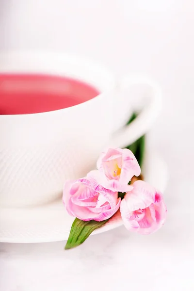 Raspberry tea and beautiful pink freesia flowers