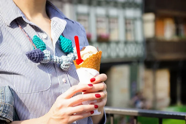 White ice cream cone in the hand