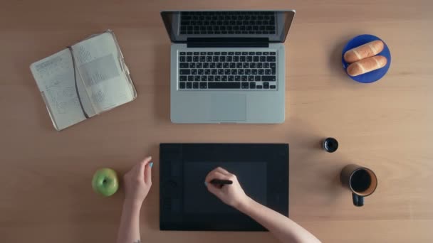 Top uitzicht ontwerper vrouw of illustrator gebruikt haar grafisch tablet en laptop maken digitale ontwerp en drinknig koffie — Stockvideo
