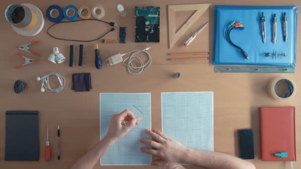 Top view industrial designer engineer drawing sketches of his project — Stock Video