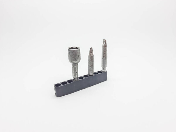 Used metal screwdriver and socket bits are stored upright in a black plastic holder, isolated on a white background for various repair tasks.