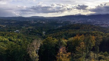 The stunning landscape features vibrant autumn colors and scenic views of valleys and majestic mountains