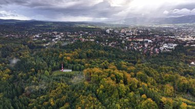A stunning aerial view beautifully showcasing vibrant autumn colors alongside impressive urban development