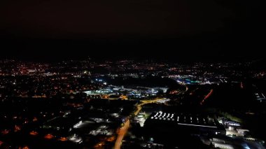 Aerial view of a vibrant city lit with countless lights at night, showcasing dynamic urban life and energy