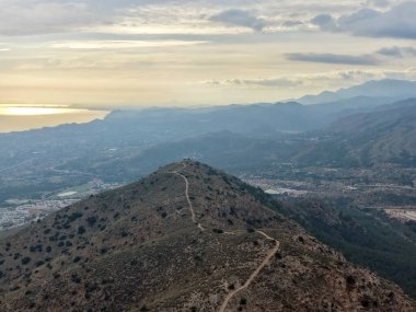 Tepe Zirvesi Altın Günbatımı Işığı, Dramatik Kıyı Ufku ve Tepelerin Üzerinde Yumuşak Parıltı, Siluet