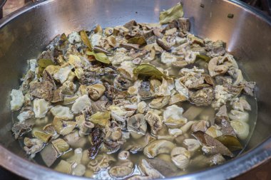 Spicy Thai Clear Tom Yum Soup with mixed Pork Offal (organ meat), simmered with fresh herbs in a large pot. This traditional Thai street food offers a rich, complex, and savory flavor.