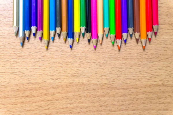 Colored pencils on a wooden board. — Stock Photo, Image