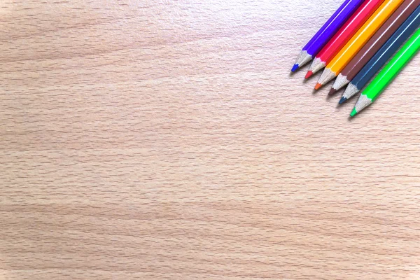 Colored pencils on a wooden board. — Stock Photo, Image