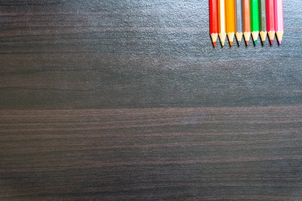 Colored pencils on a wooden board. — Stock Photo, Image
