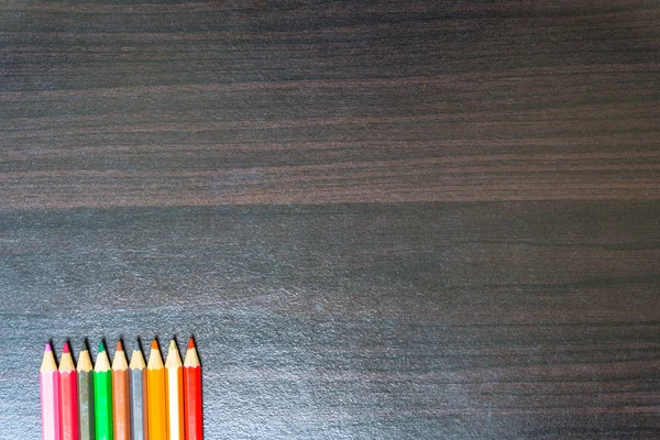 Colored pencils on a wooden board. — Stock Photo, Image